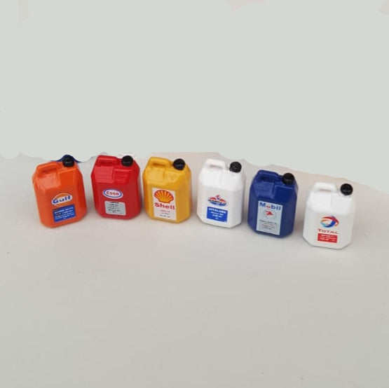Collection of miniature oil cans with various brand logos
