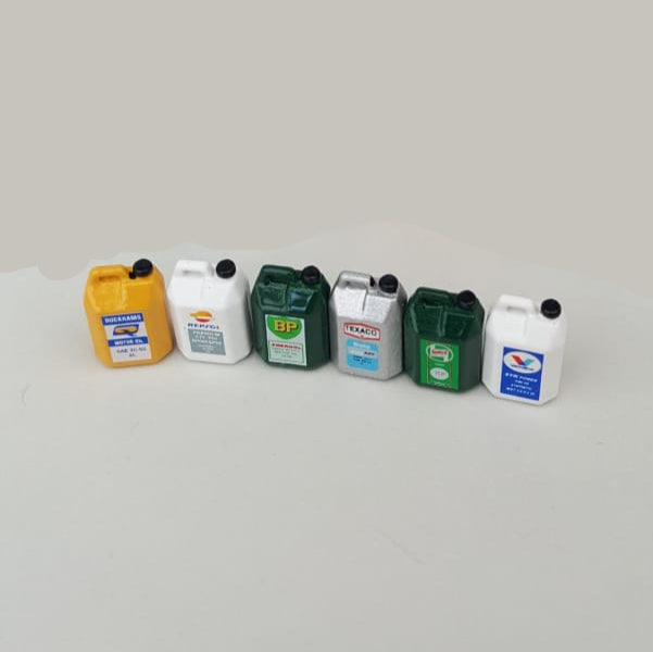Collection of various oil containers on a white background